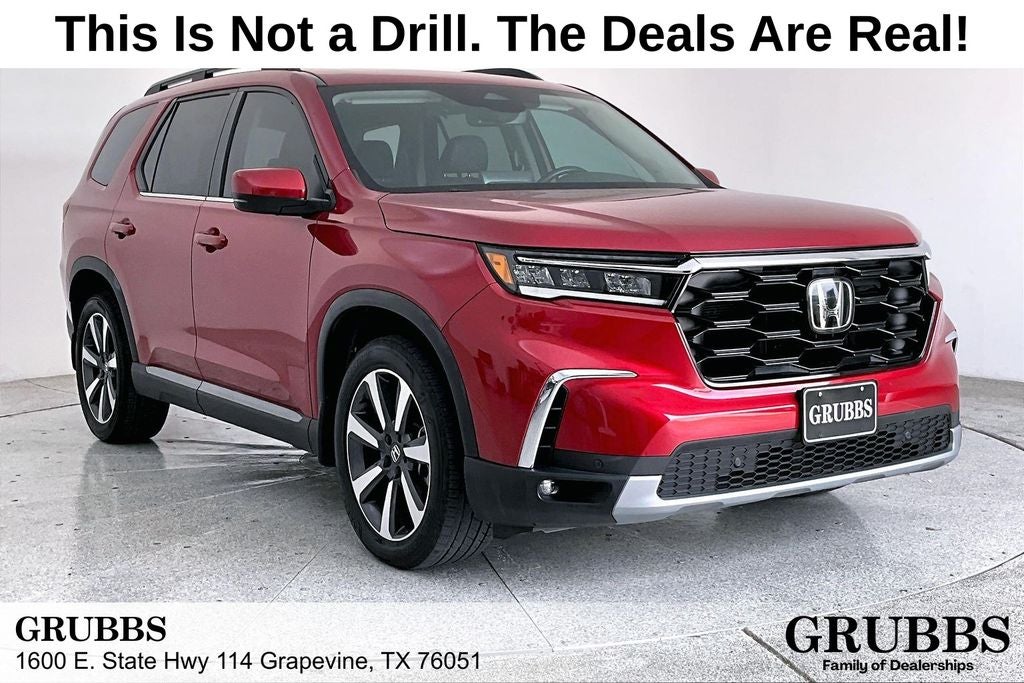 2023 Honda Pilot Touring in Radiant Red Metallic II — front three-quarter view